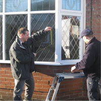 A beutiful new timber bay window with leaded lights gets a final check from Karl & Andy